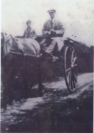 Copy of an undated photograph of Stanley Thomas and unnamed child in a horse drawn cart